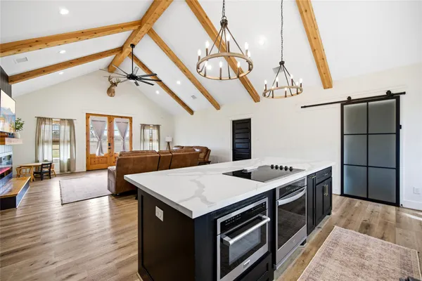 a kitchen with a stove and a wooden floor