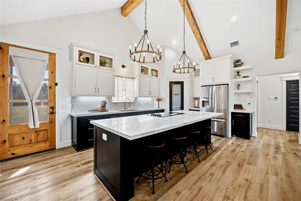a kitchen with stainless steel appliances granite countertop a sink stove and wooden floor