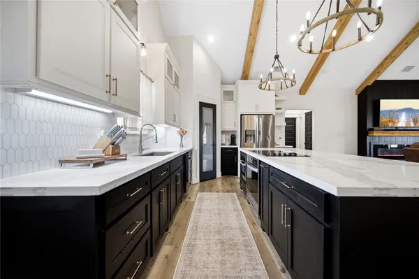 a kitchen with stainless steel appliances sink stove and cabinets
