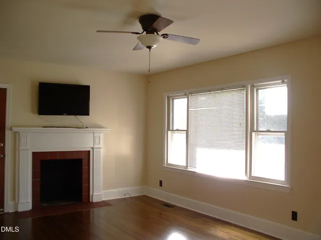 a living room with a fireplace and a flat screen tv