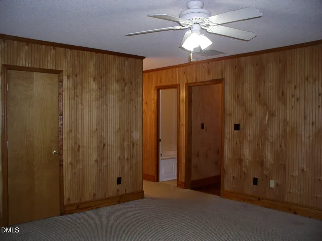 a view of a closet with a chandelier fan
