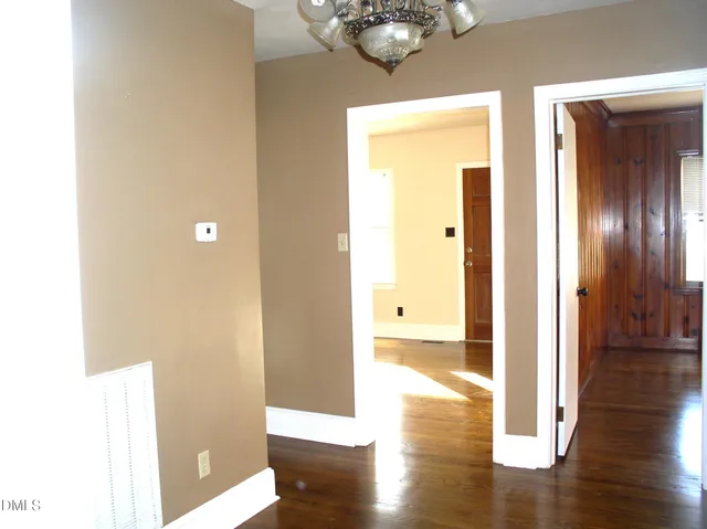 a view of a hallway with wooden floor