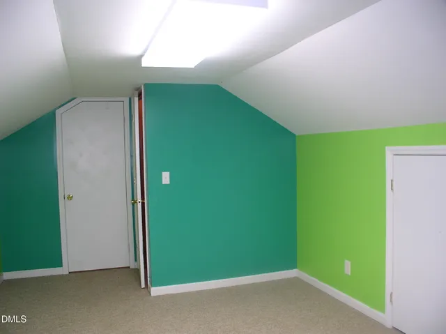 a kitchen with granite countertop white cabinets and a wooden door