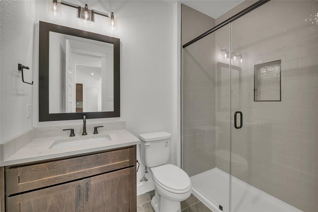 229 Lasso Loop Lorena, TX 76655 - Photo 19 of 30 a bathroom with a sink a toilet and shower
