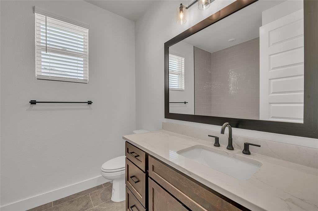 229 Lasso Loop Lorena, TX 76655 - Photo 22 of 30 a bathroom with a sink a toilet and a mirror