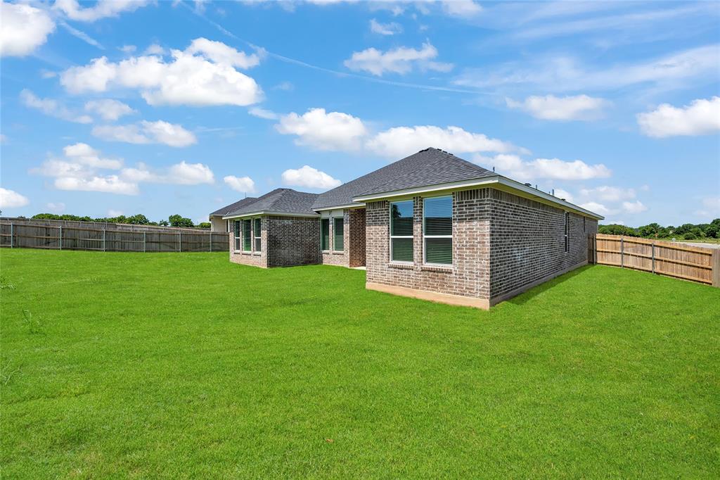 229 Lasso Loop Lorena, TX 76655 - Photo 27 of 30 a front view of a house with a garden