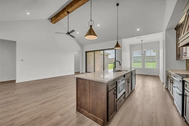 a view of a kitchen with a sink and a window