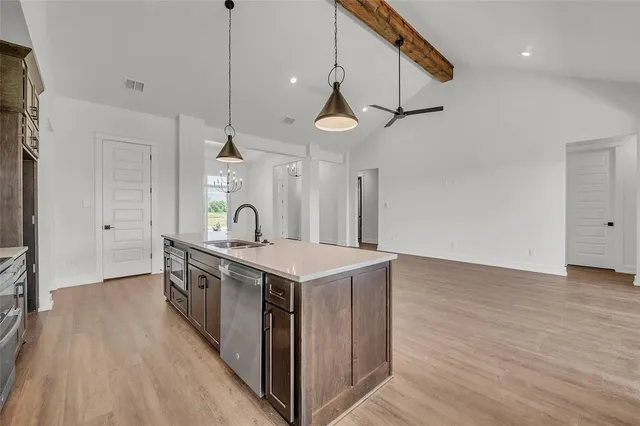 a kitchen with stove and wooden floor