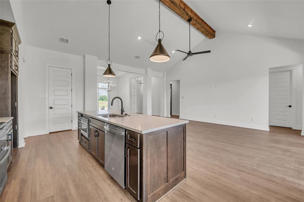229 Lasso Loop Lorena, TX 76655 - Photo 5 of 30 a kitchen with wooden floor and a sink