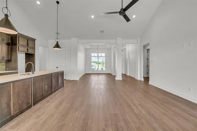 a kitchen with wooden floor and a sink