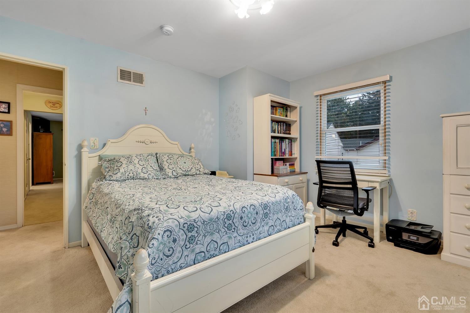 38 Homestead Road Edison, NJ 08820 - Photo 11 of 15 a bedroom with a bed a mirror and a window