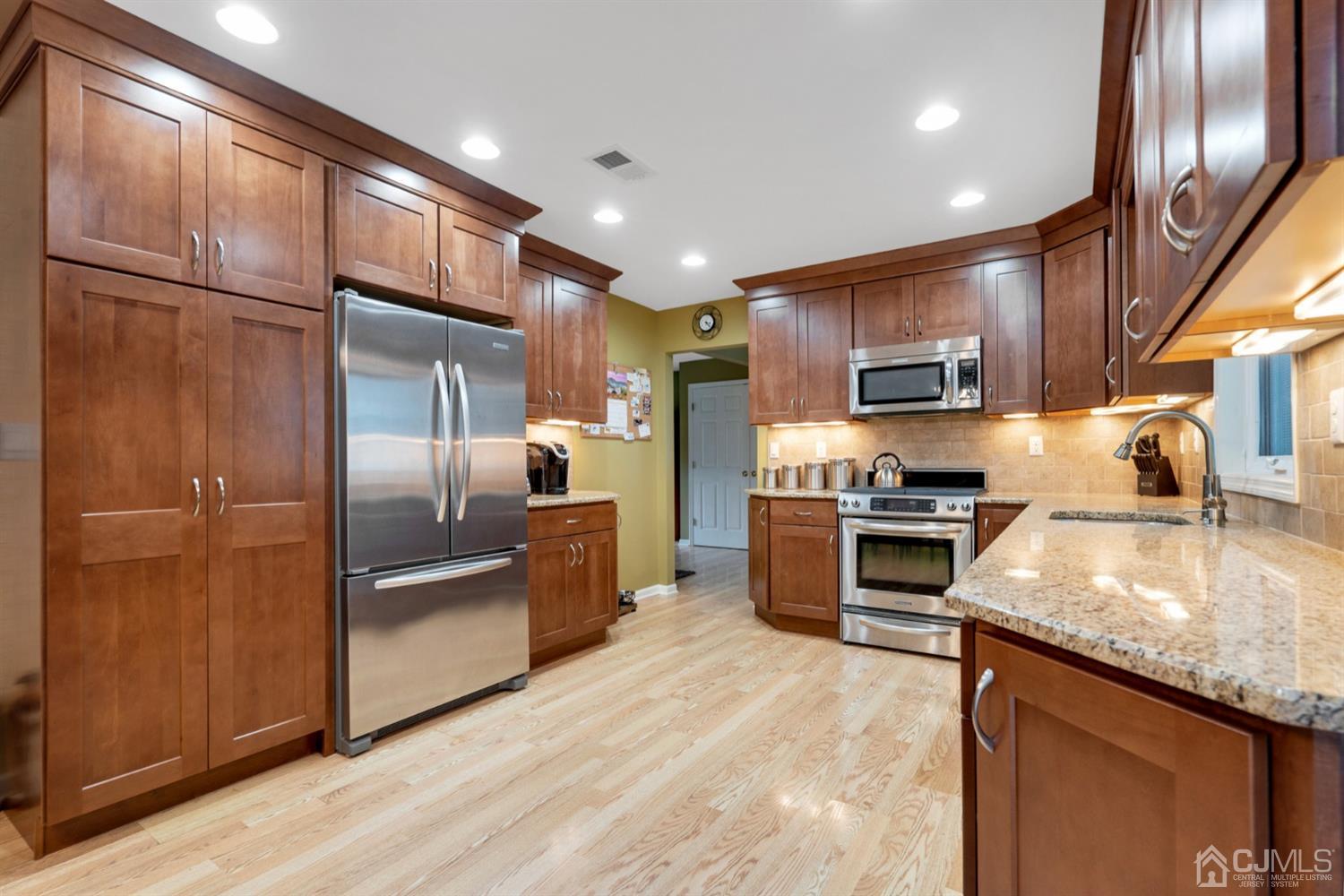 38 Homestead Road Edison, NJ 08820 - Photo 4 of 15 a kitchen with kitchen island granite countertop stainless steel appliances and a refrigerator