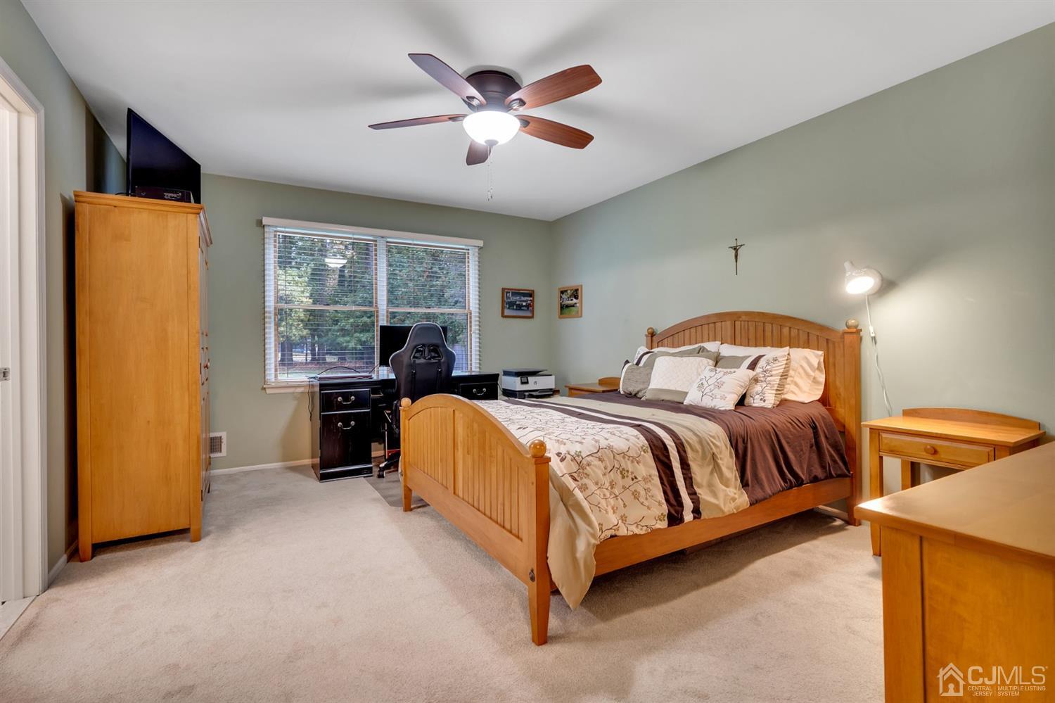 38 Homestead Road Edison, NJ 08820 - Photo 10 of 15 a spacious bedroom with a bed and a chandelier