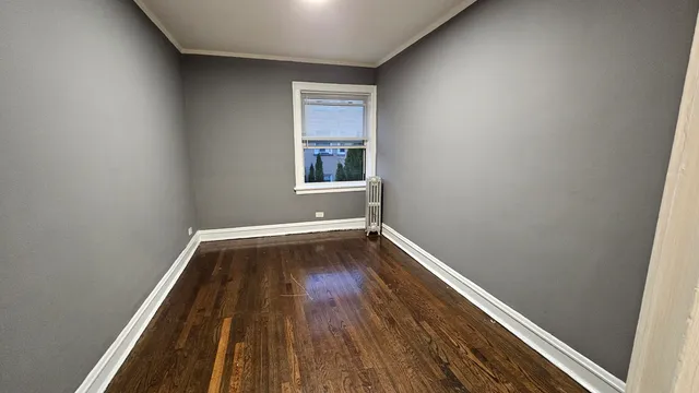a view of a room with wooden floor and window