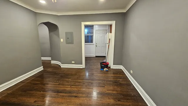 a view of an empty room with wooden floor