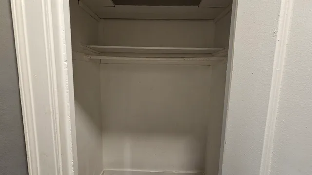 a bathroom with a shower and a wooden door