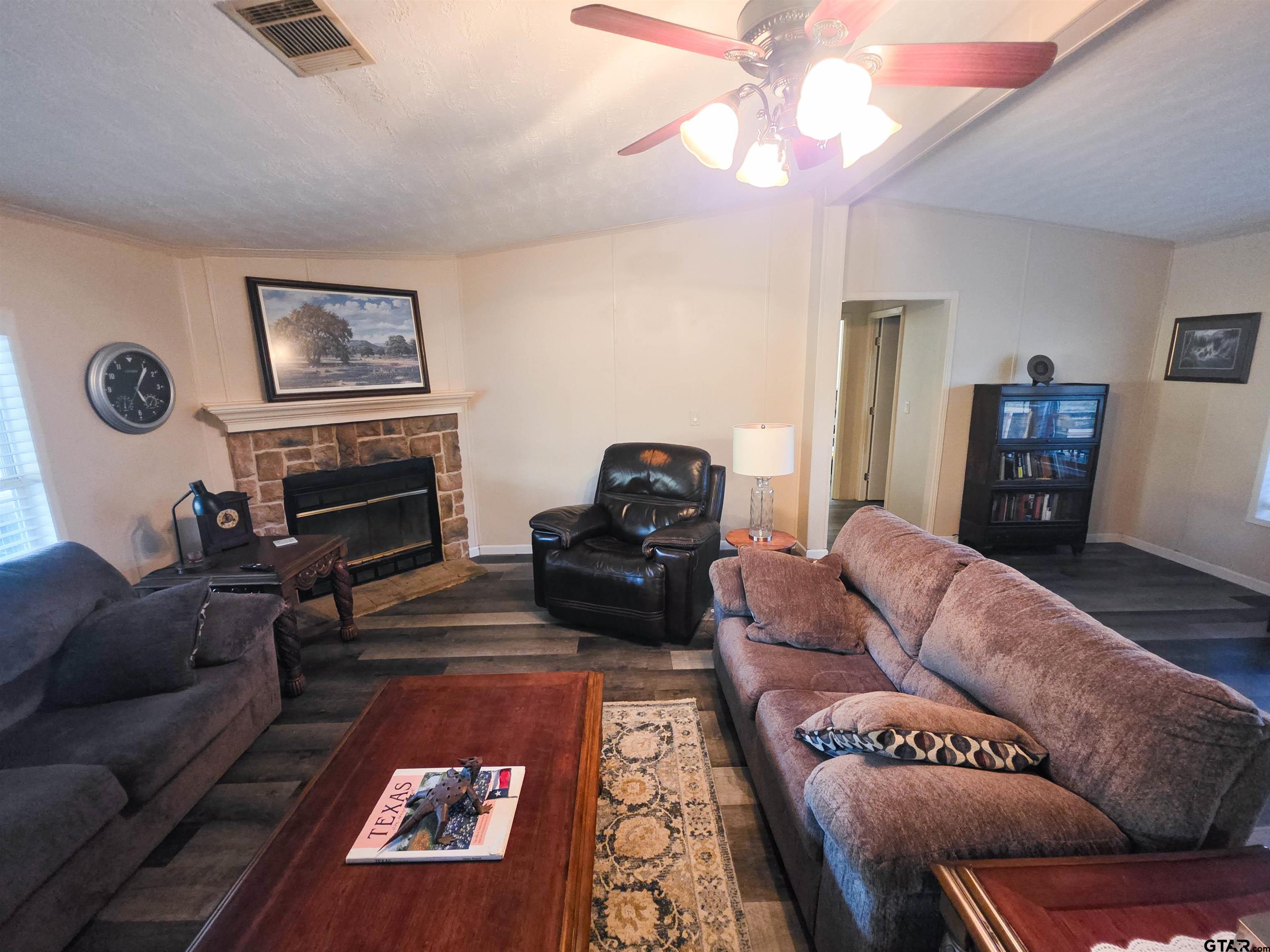 12507 Dingler Road Tyler, TX 75709 - Photo 11 of 26 a living room with furniture and a fireplace