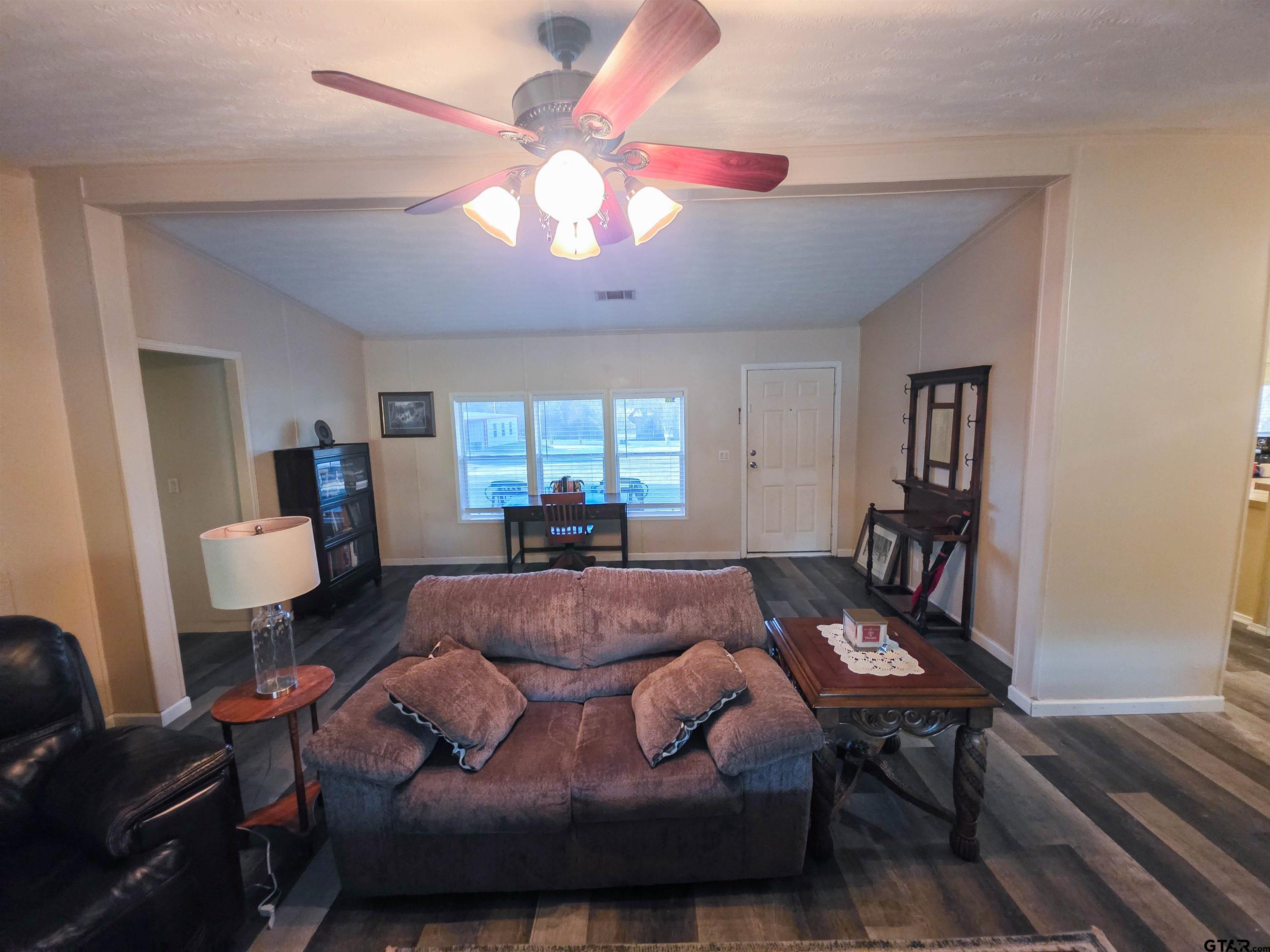 12507 Dingler Road Tyler, TX 75709 - Photo 12 of 26 a living room with furniture and a chandelier