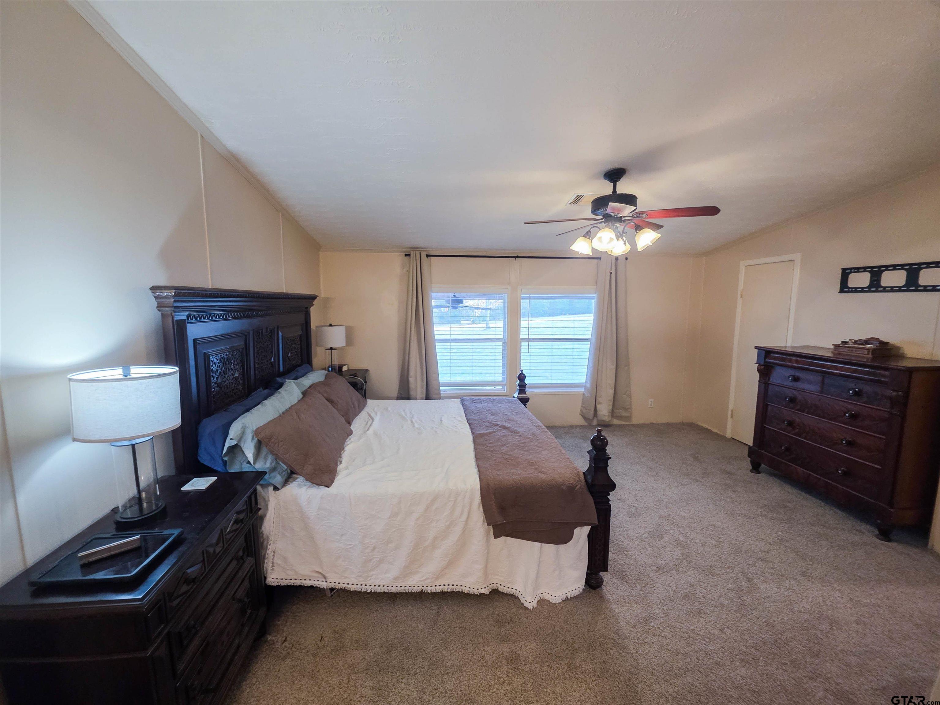 12507 Dingler Road Tyler, TX 75709 - Photo 19 of 26 a bed room with a bed and a mirror