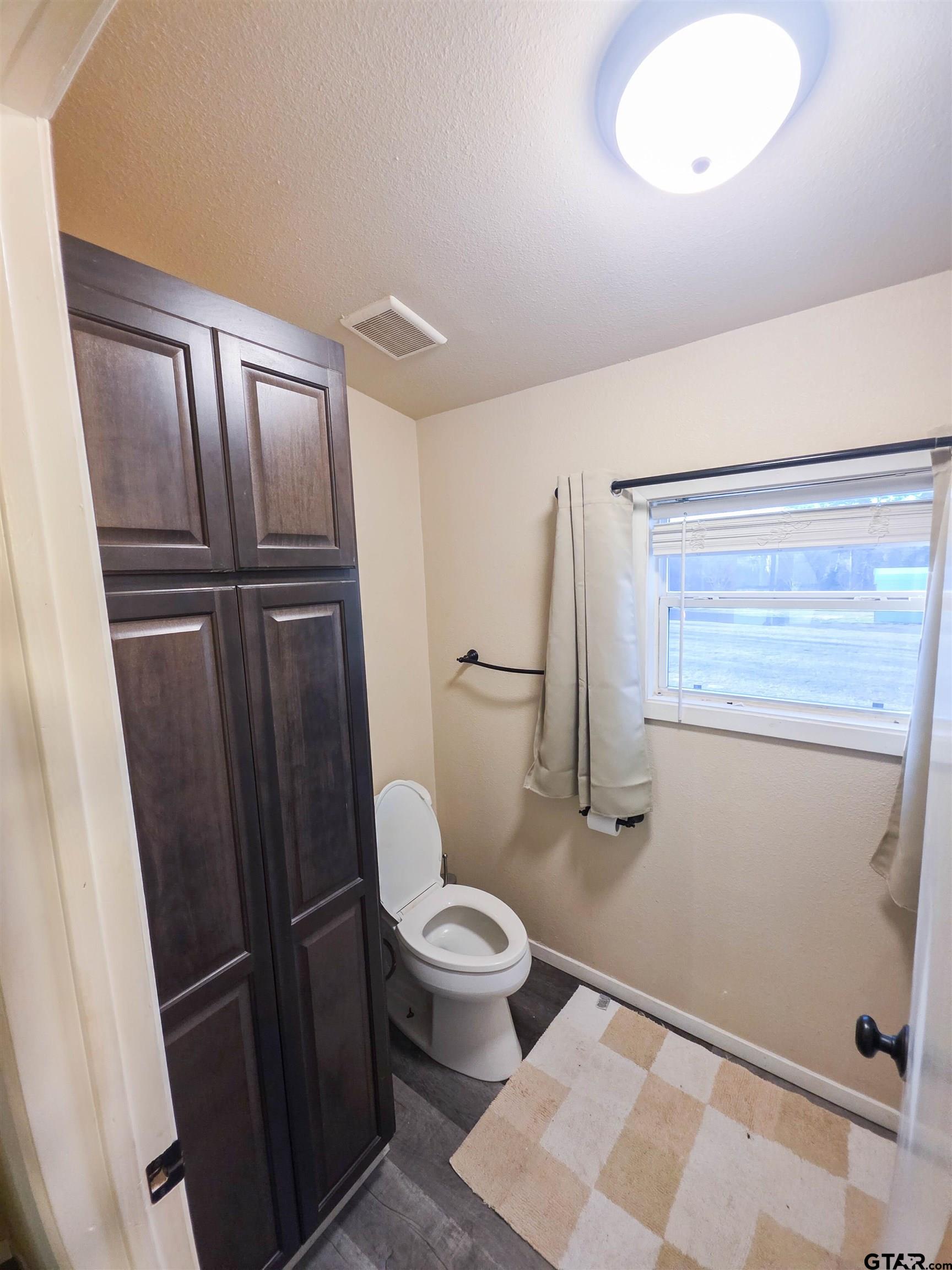 12507 Dingler Road Tyler, TX 75709 - Photo 21 of 26 a bathroom with a toilet and a shower
