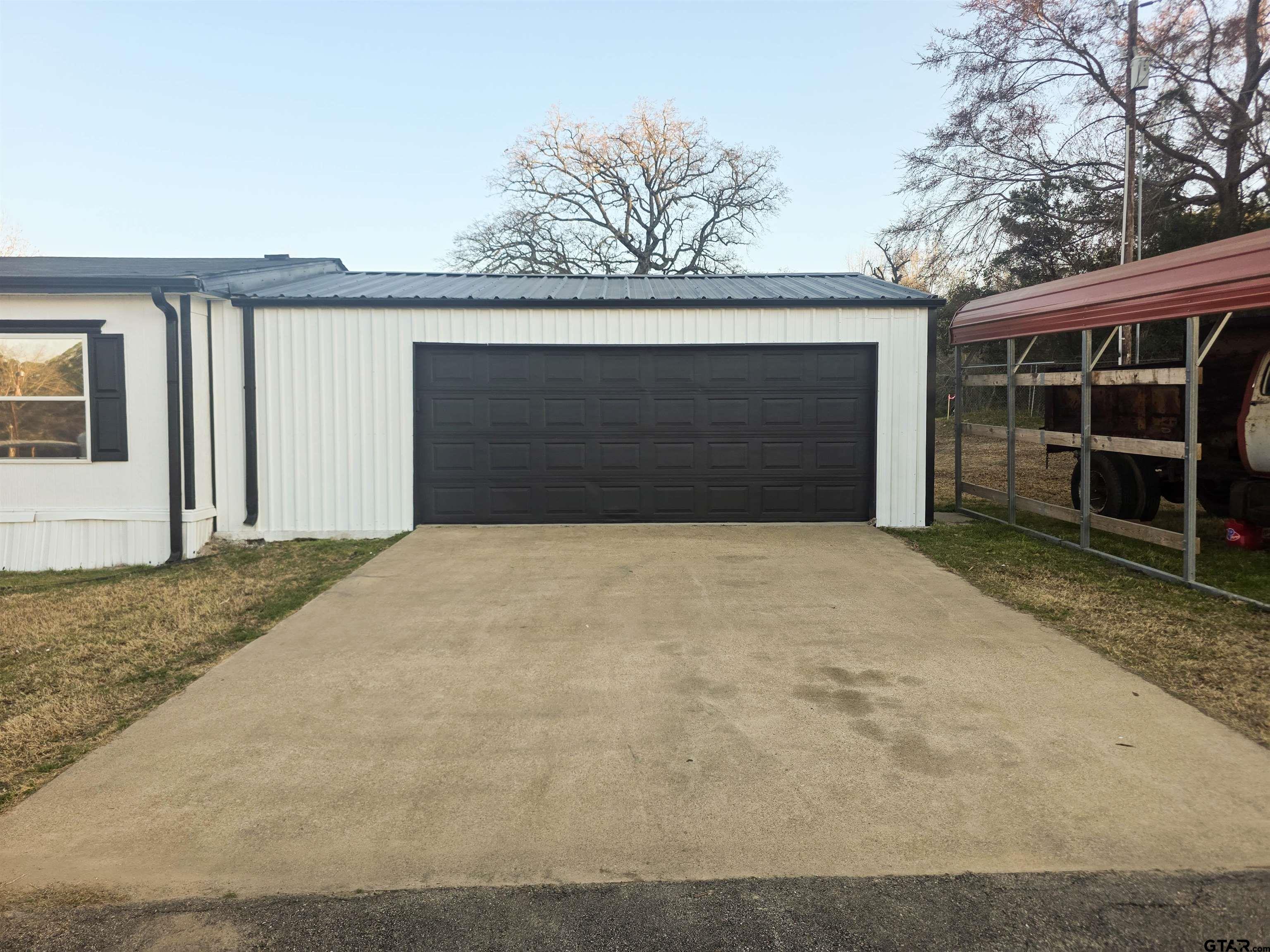 12507 Dingler Road Tyler, TX 75709 - Photo 7 of 26 a front view of a house with a yard and garage
