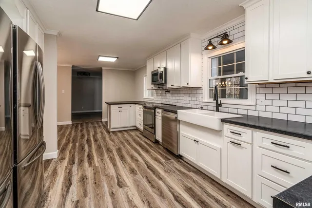 a kitchen with stainless steel appliances granite countertop a refrigerator and a sink