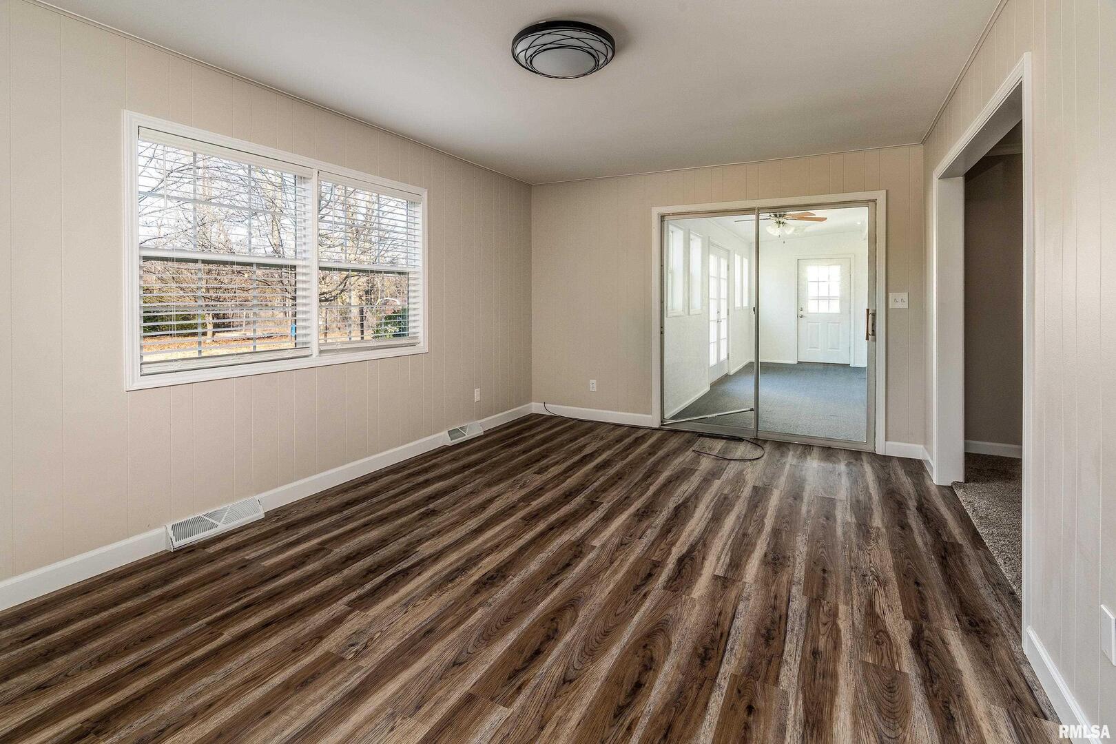 203 Fairway Vista Road Murphysboro, IL 62966 - Photo 22 of 44 a view of an empty room with wooden floor and a window