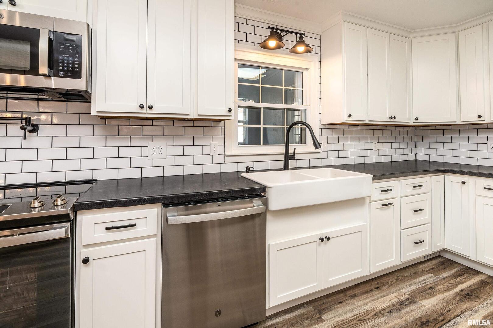 203 Fairway Vista Road Murphysboro, IL 62966 - Photo 10 of 44 a kitchen with granite countertop a sink stainless steel appliances and cabinets