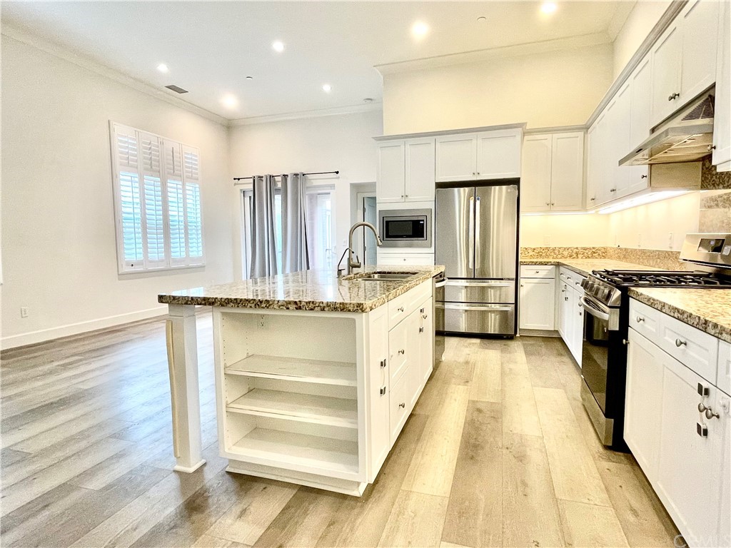96 Kempton Irvine, CA 92620 - Photo 1 of 1 a kitchen with stainless steel appliances a refrigerator and a stove