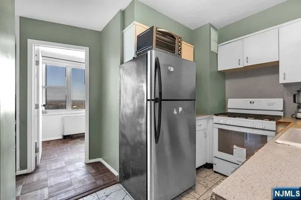 a kitchen with stainless steel appliances a refrigerator sink and cabinets