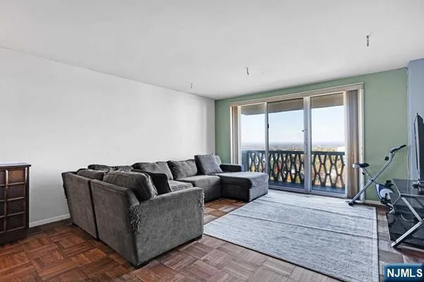 a living room with furniture and a floor to ceiling window