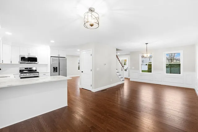 a view of a kitchen with furniture and wooden floor