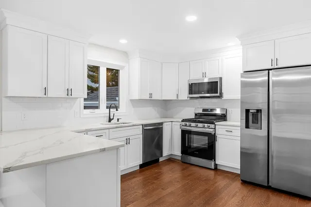 a kitchen with a sink stove and refrigerator