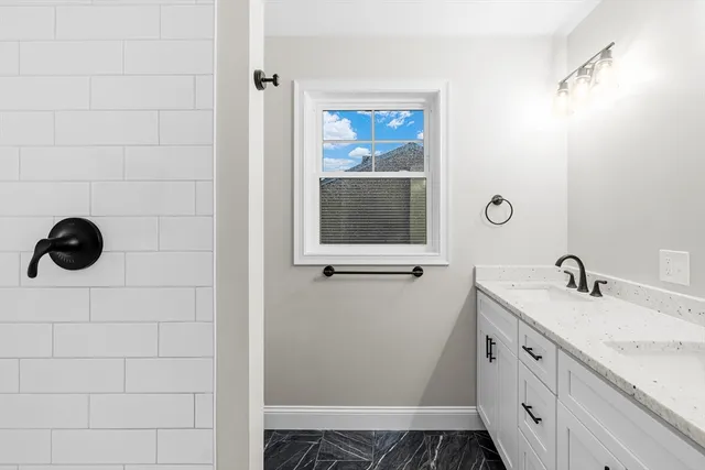 a bathroom with a sink and mirror