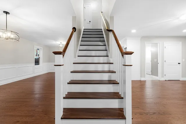 a view of entryway and hall with wooden floor