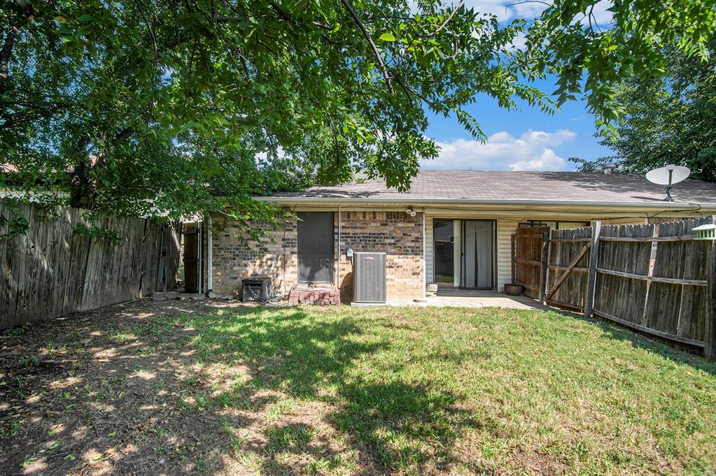 6819 West Cleburne Road Fort Worth, TX 76133 - Photo 23 of 24 a front view of a house with a yard
