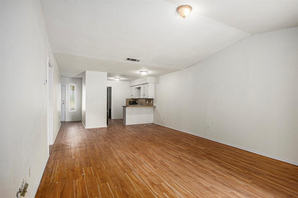6819 West Cleburne Road Fort Worth, TX 76133 - Photo 6 of 24 a view of a kitchen with a sink and a refrigerator