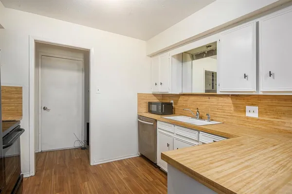 a kitchen with a sink and cabinets