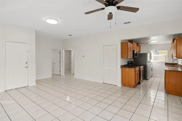 a view of kitchen with furniture and refrigerator
