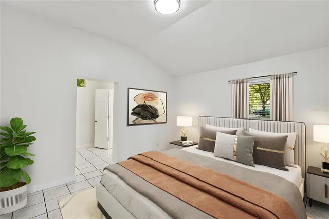 a bedroom with a bed and a potted plant