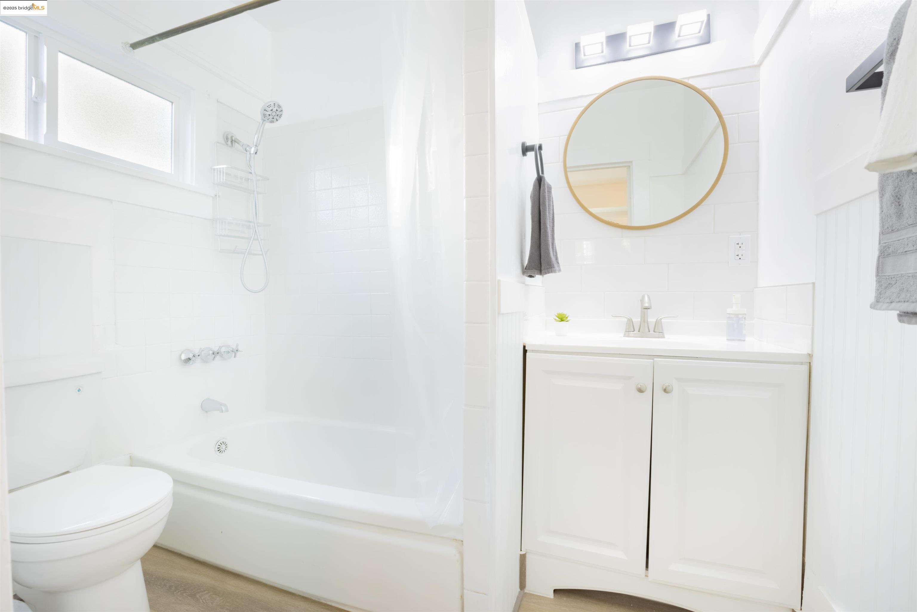 400 Lagunitas Avenue Oakland, CA 94610 - Photo 11 of 14 a bathroom with a sink a toilet and a mirror