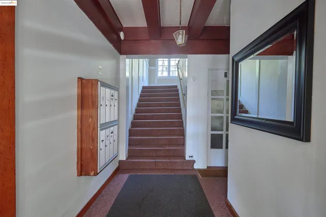 a view of a hallway with wooden walls and entryway