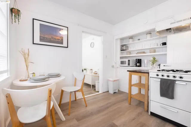 a dining room with furniture and wooden floor