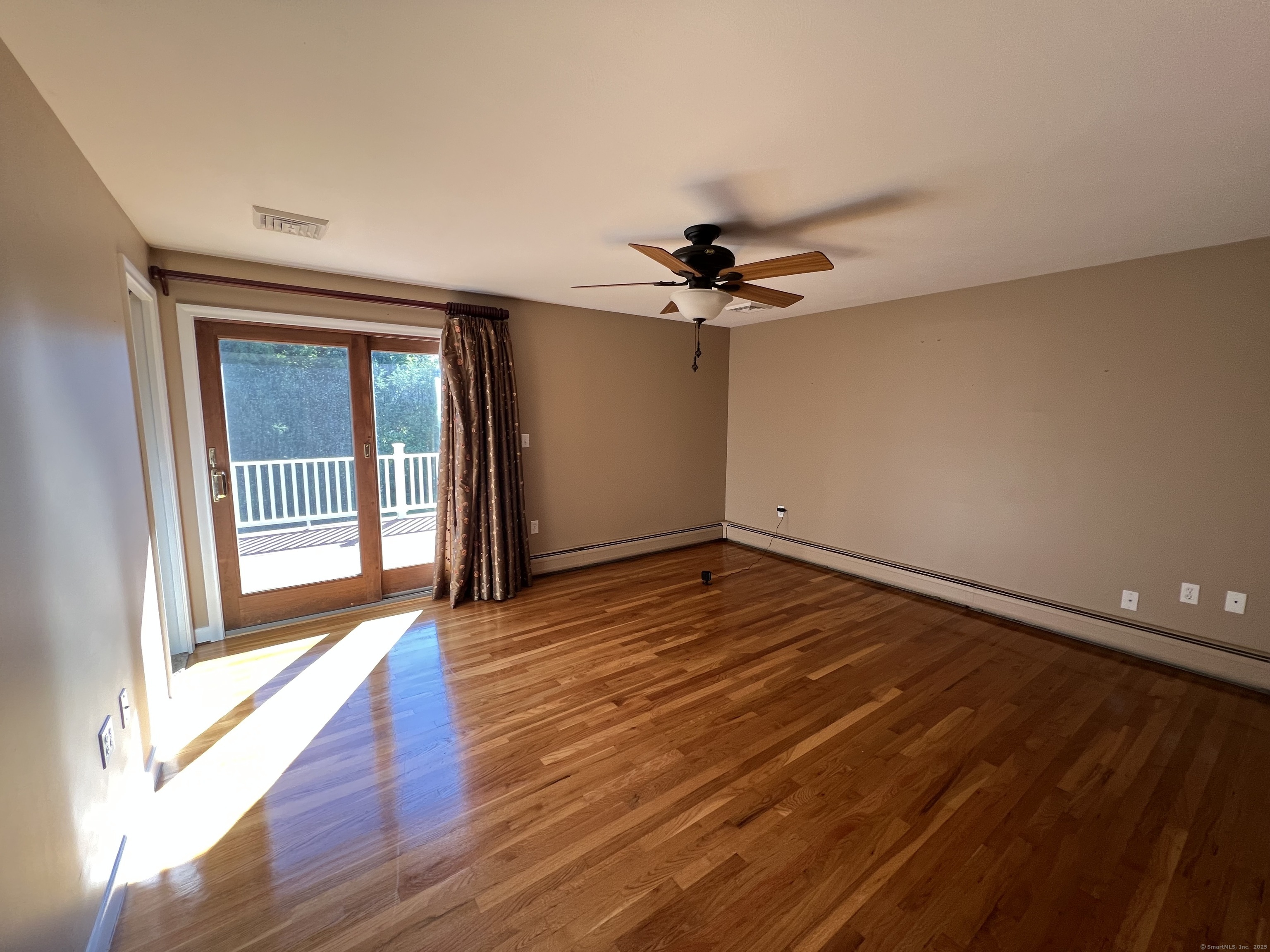 104 Willow Street Wethersfield, CT 06109 - Photo 11 of 28 a view of a livingroom with wooden floor and a ceiling fan