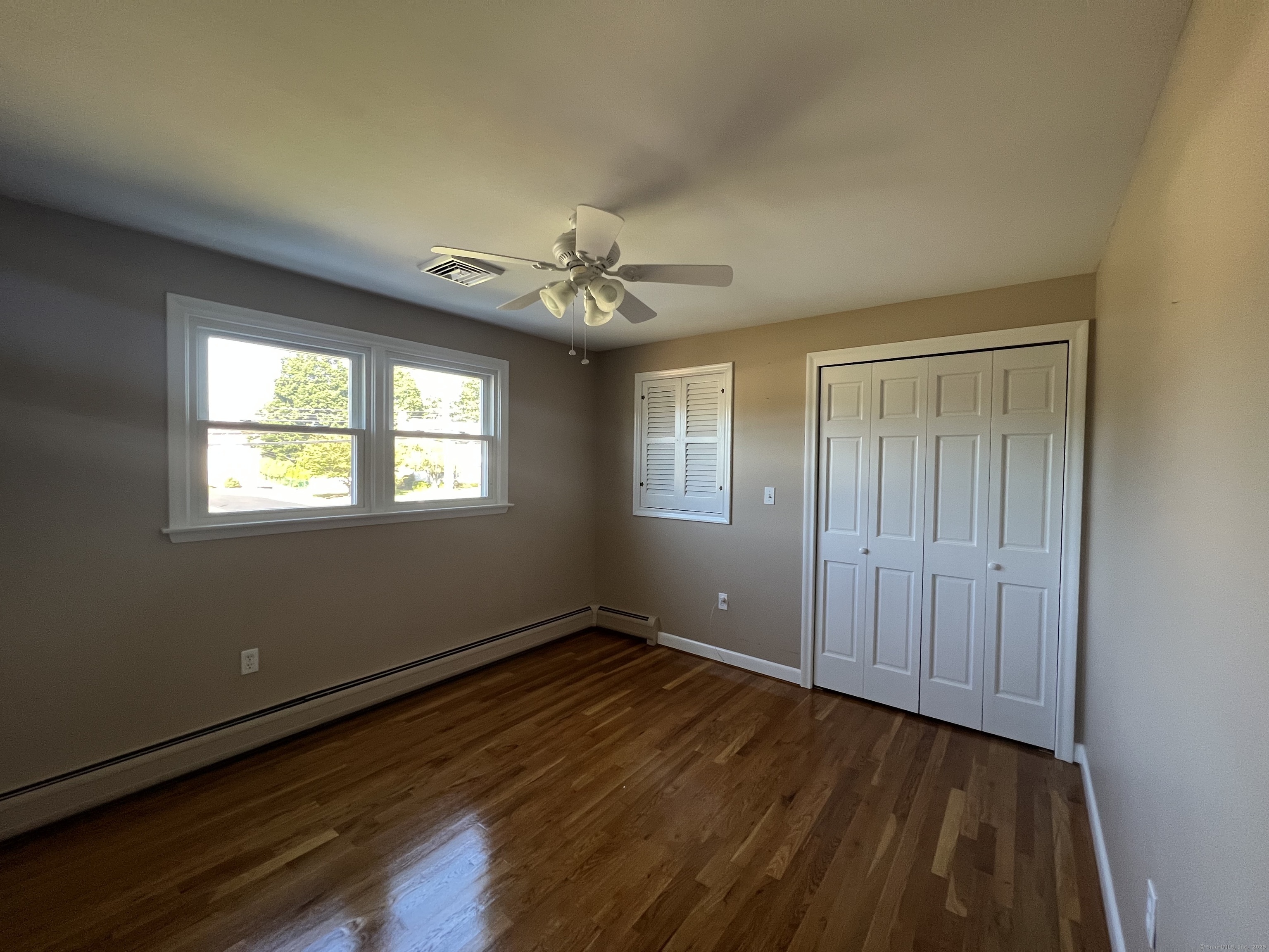 104 Willow Street Wethersfield, CT 06109 - Photo 16 of 28 a view of an empty room with wooden floor and a window