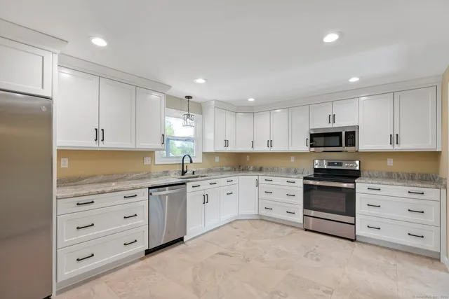 a kitchen with a sink stove and refrigerator