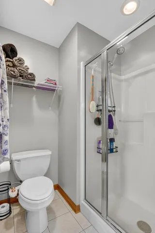 a bathroom with a toilet and a shower
