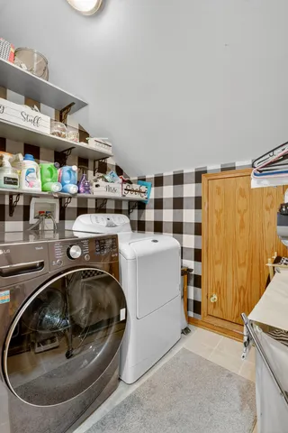 a utility room with sink dryer and washer
