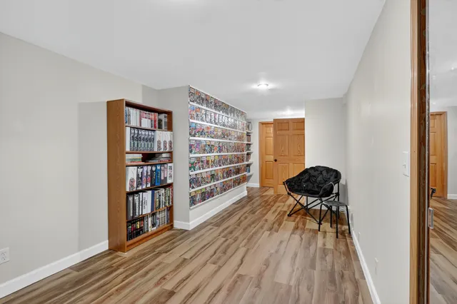a living room with furniture and a book shelf