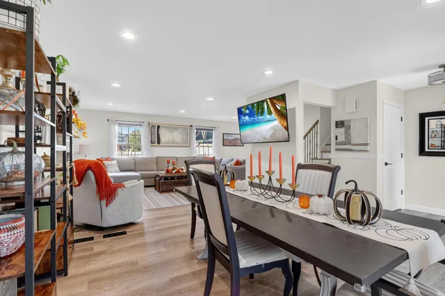a living room with lots of furniture and kitchen view